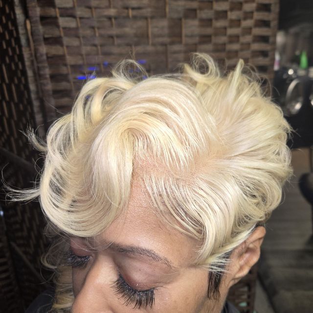Bright blonde tapered pixie styled with volume and shine