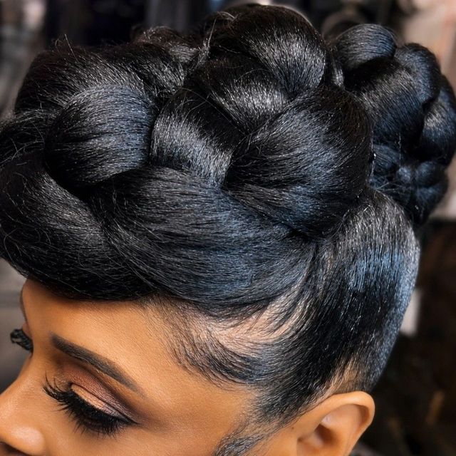 Sleek black braided crown updo with polished edges
