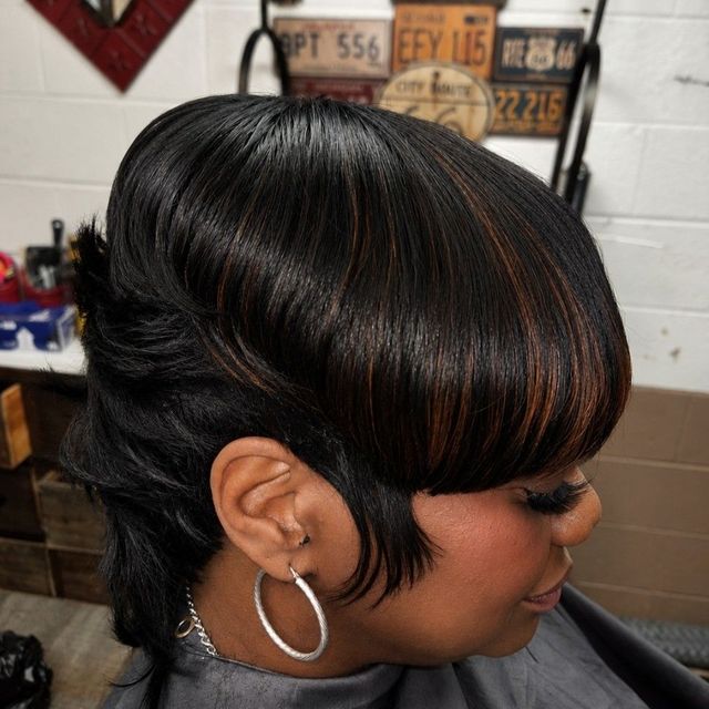 Short black cut with copper highlights and a full fringe