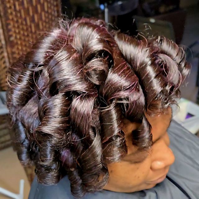 Glossy burgundy barrel curls set close to the head