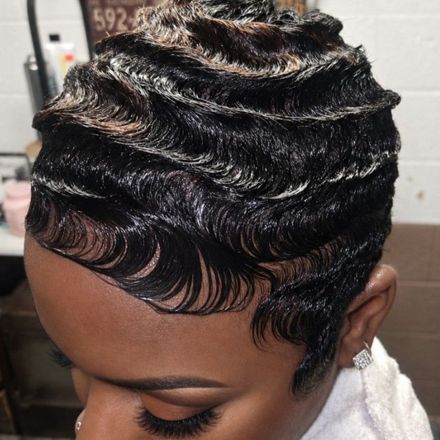 Short black hair styled in sculpted finger waves with blonde streaks