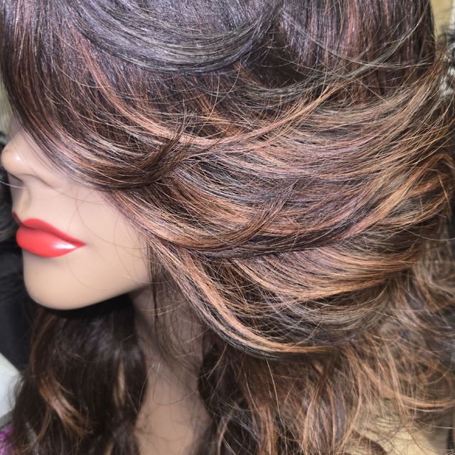 Layered blowout with caramel highlights and feathered ends