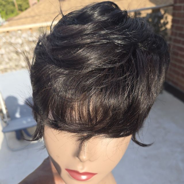 Dark feathered pixie wig unit styled with volume