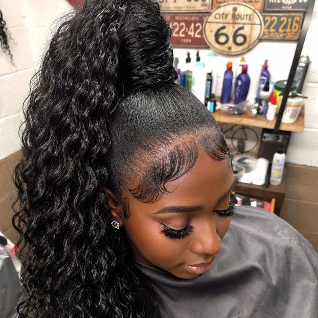 High curly ponytail with sleek base and laid edges