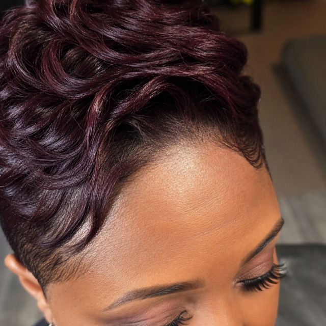Burgundy tapered short cut with sculpted waves and laid edges