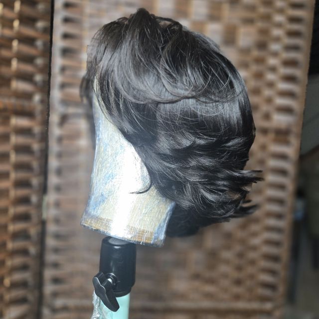 Side view of a glossy black feathered layered bob