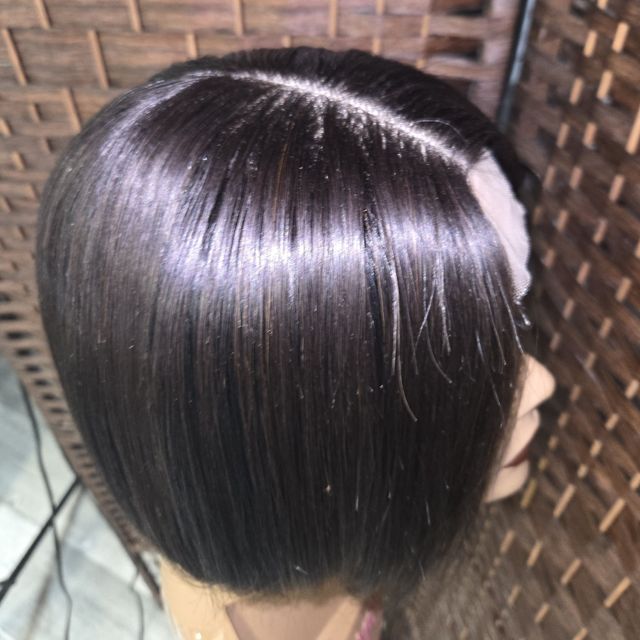 Glossy silk-pressed dark bob with a clean part